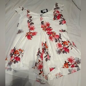A cute summer romper outfit , white with pink and orange flowers.